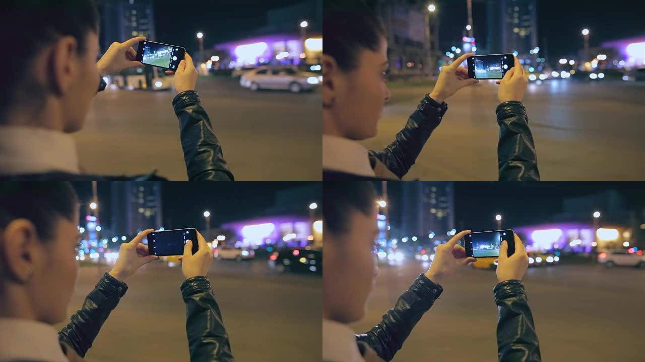 城里的女人用智能手机拍照。
