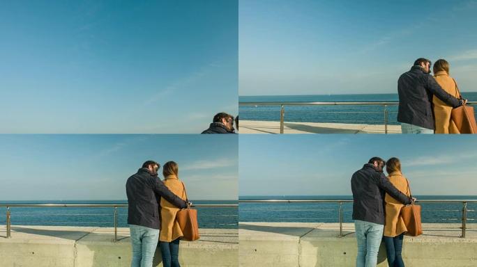 相爱的夫妇看着海景。