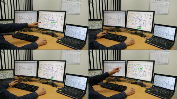 年轻的工程师用显示器操作电脑