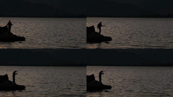 日落中渔民的剪影