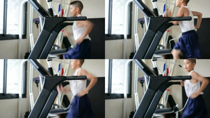 亚洲孩子在健身跑步机上跑步。