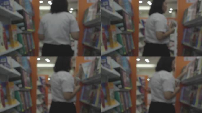 书店的学生书架前模糊的人影找书读书