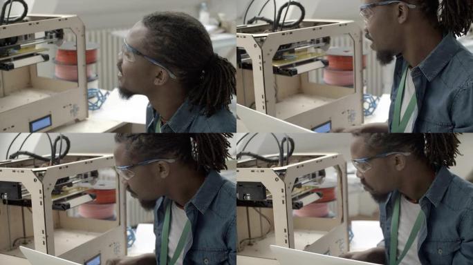 高清：非洲裔美国人在3D打印机旁工作。