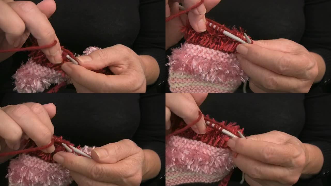女士手用粉色羊毛编织Purl缝线特写