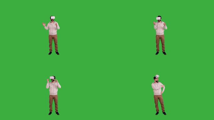 戴着虚拟现实眼镜的年轻人在绿色背景上展示了复制空间