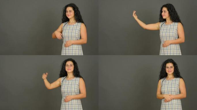 穿着灰色背景夏装的漂亮年轻女子。