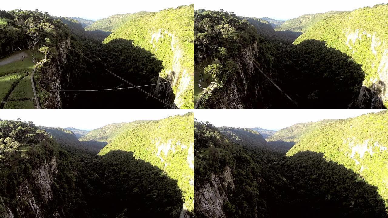 人类穿越山谷瀑布上方的高线
