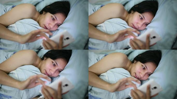 女性在床上使用智能手机