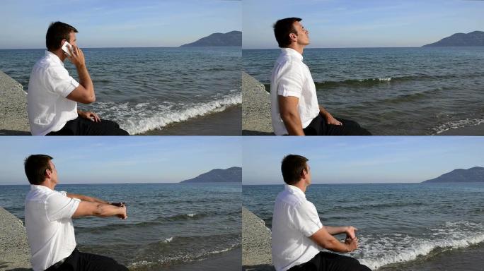 坐在海边的男人。坐在海边的男人手机通话打