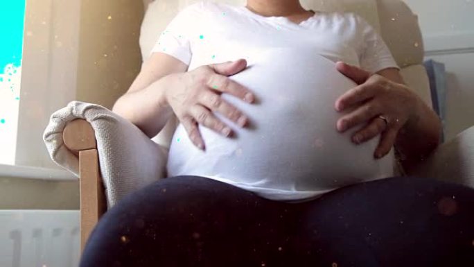 孕妇抚摸她的肚子。高清