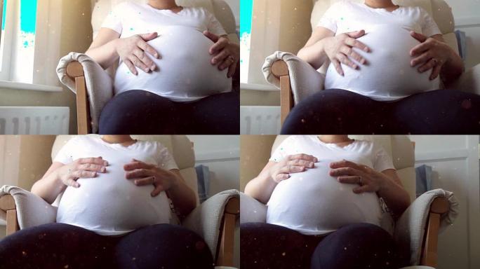 孕妇抚摸她的肚子。高清