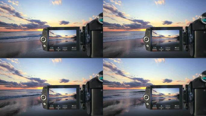 摄像机在海滩上记录日落