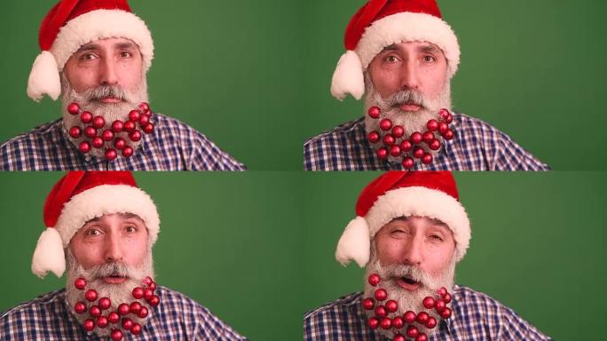 戴着圣诞老人优雅帽子的大胡子的成年男子看着镜头，开心地唱歌摇头