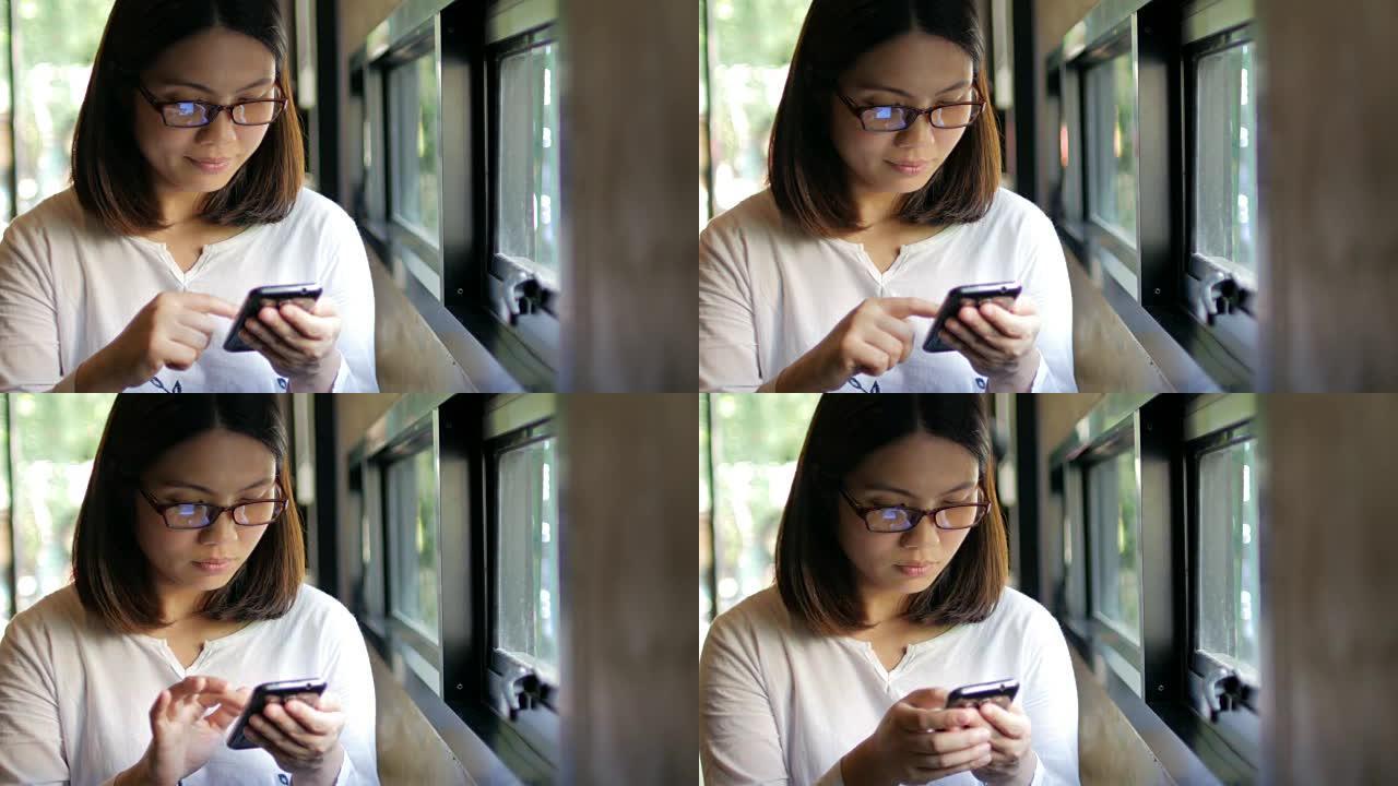 年轻女子在咖啡厅触摸智能手机，生活方式概念，4k(UHD)