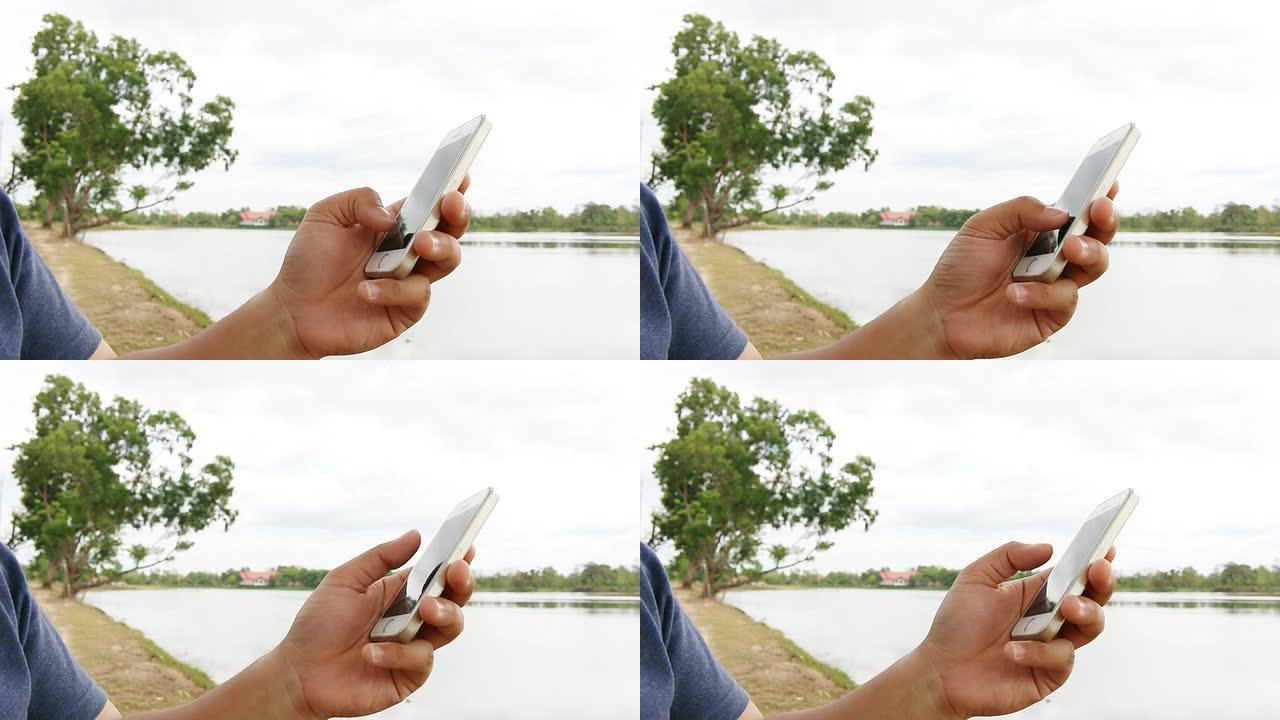 在自然和河流中使用智能手机的人