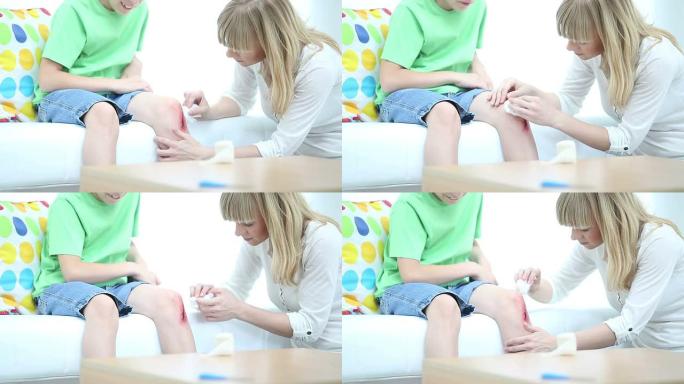 高清: 母亲清洁儿子擦伤了膝盖。
