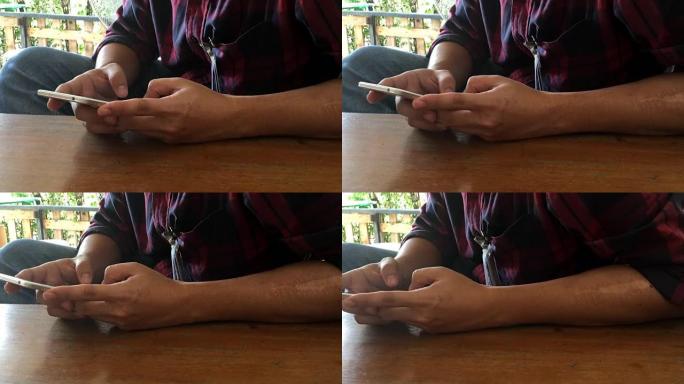 男子手触摸和滚动智能手机绿屏