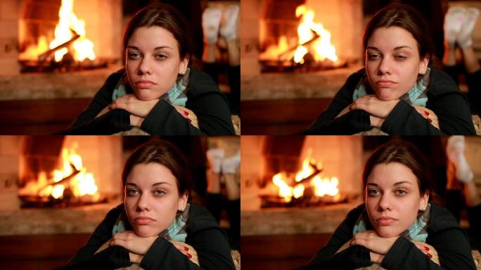 在壁炉旁思考发呆的外国女人燃烧的篝火