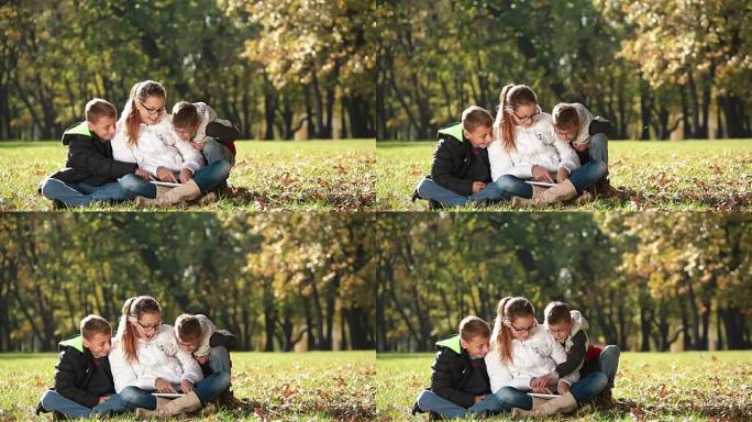 孩子们在大自然中享受数字平板电脑的乐趣