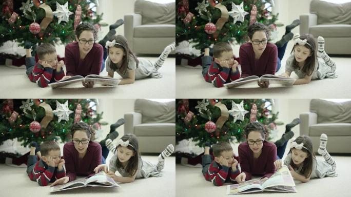 年轻的母亲在圣诞节前夕与孩子们一起读书