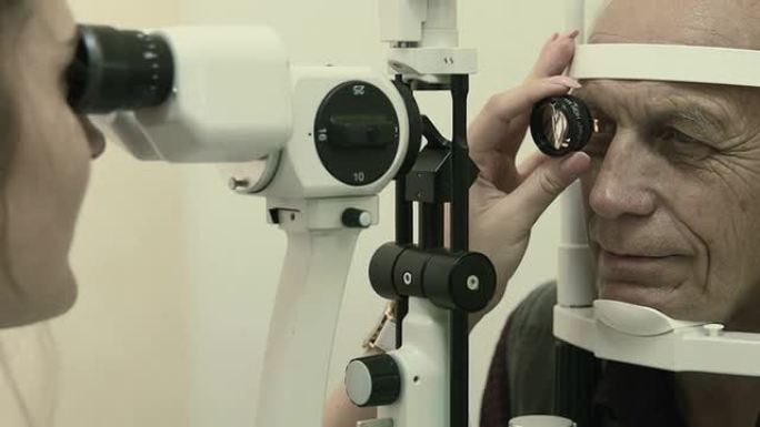 Optometrist examines man's eyesight