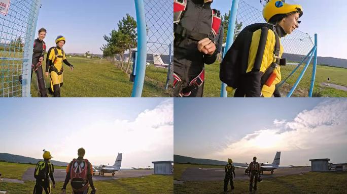 两名快乐的女跳伞运动员走向飞机