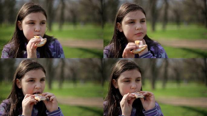 小女孩在公园里吃饭