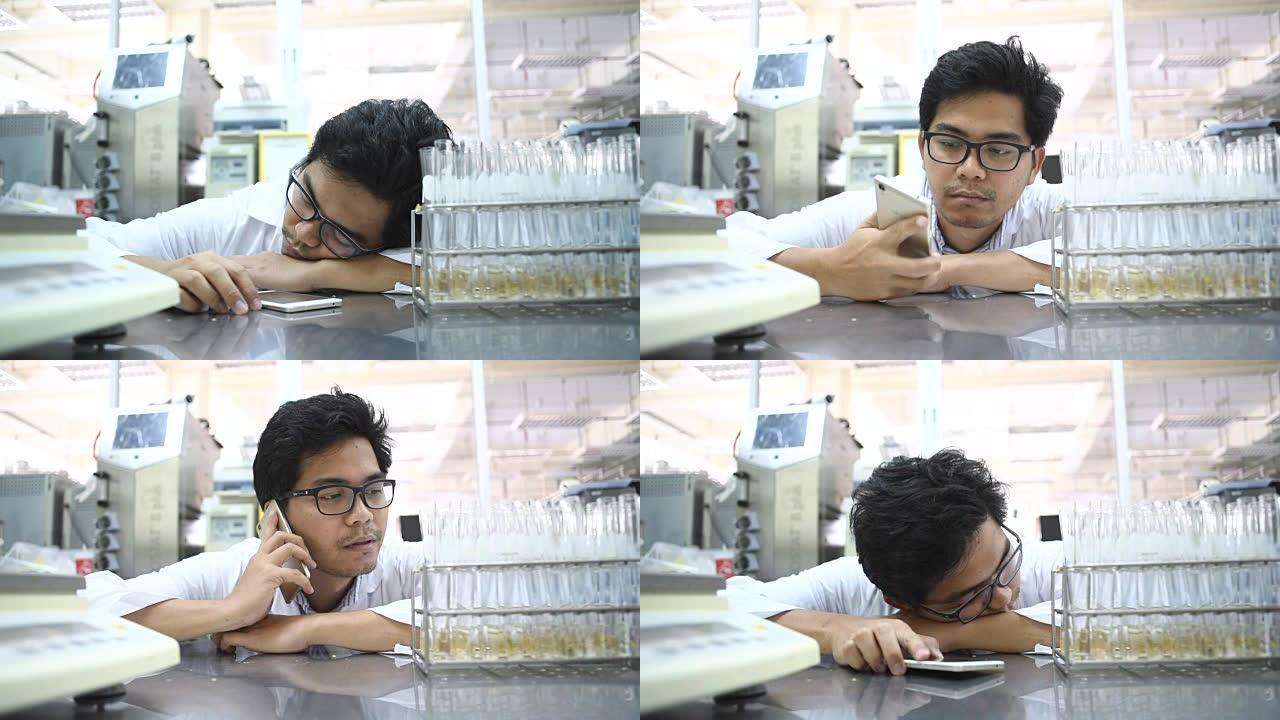 年轻的亚洲男性科学家在实验室睡觉