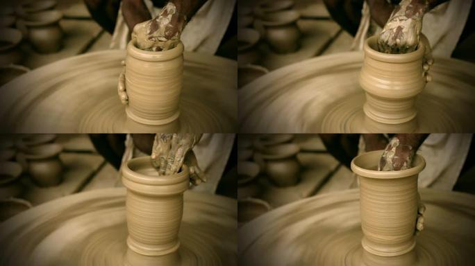印度陶工在手动陶轮上熟练地手工成型壶