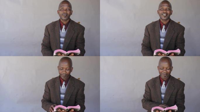 非洲男子满怀信心地阅读圣经