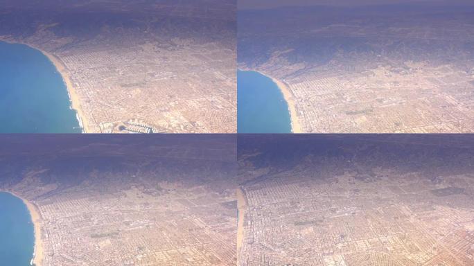 鸟瞰图洛杉矶郊区和海滩飞机窗户4k