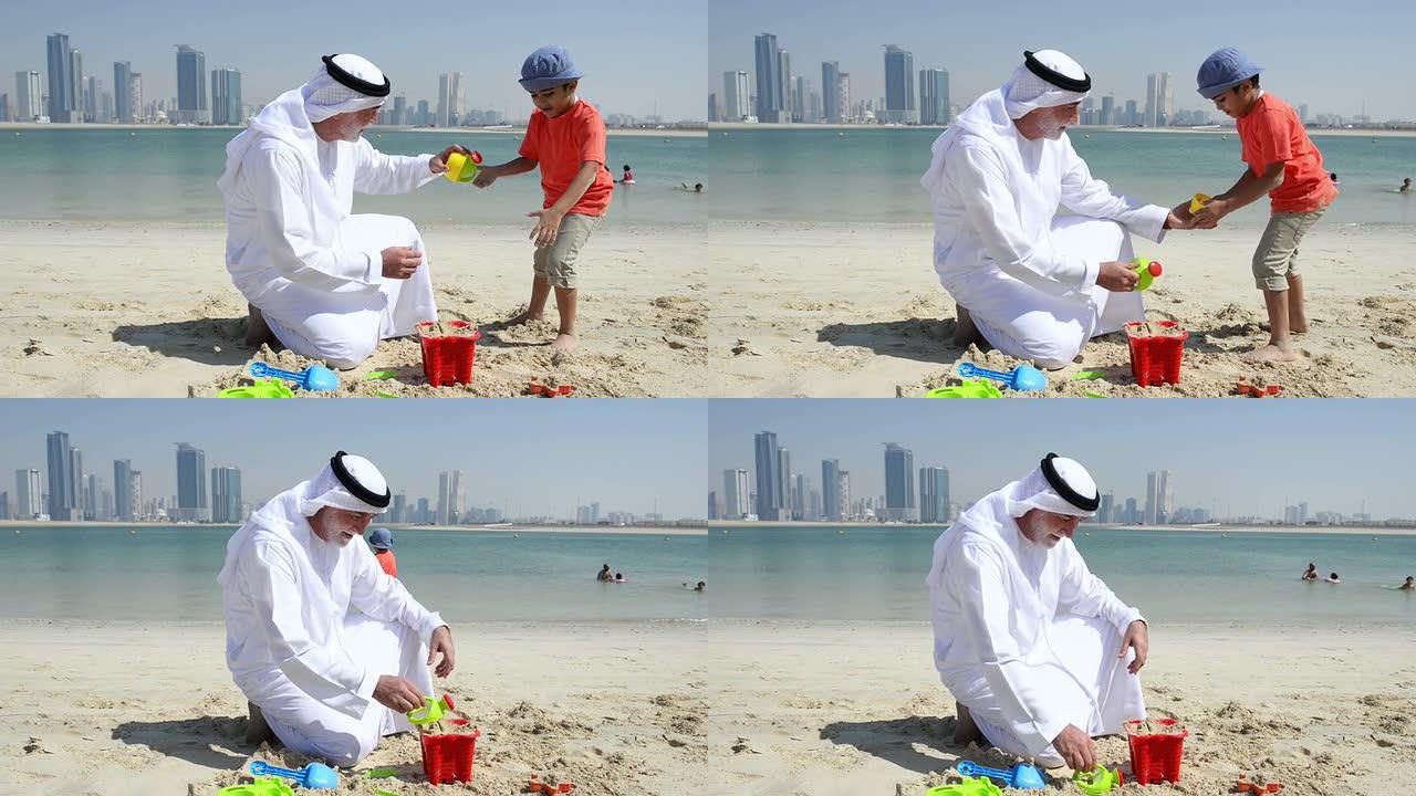 阿联酋祖父和小男孩在海滩上玩耍