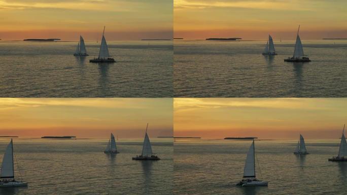 日落时的帆船海水上的帆船三只船只