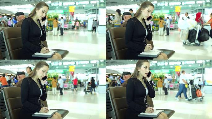 高清：女商人在机场使用手机工作。。