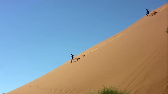 两个人在沙丘上奔跑