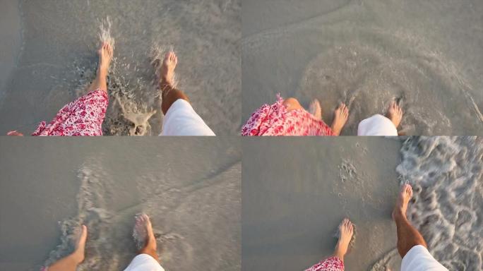 情侣们沿着空旷的海滩散步，视线朝向脚下