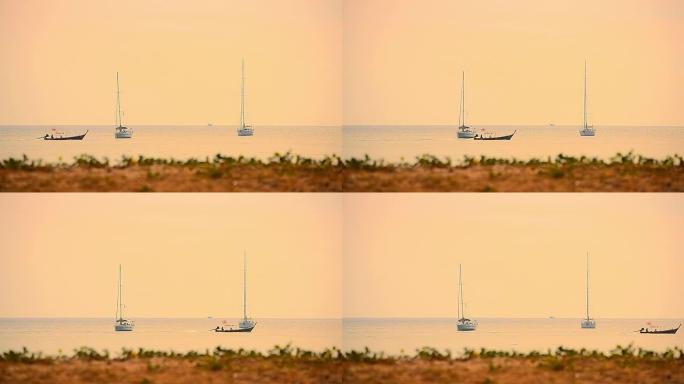 热带日落海滩上的帆船