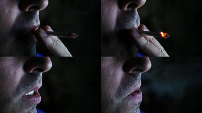 一个男人在黑色背景上抽烟的特写镜头