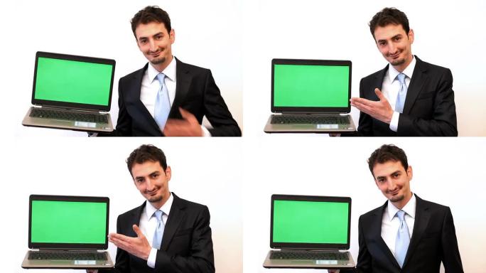 商人展示带绿屏的笔记本电脑