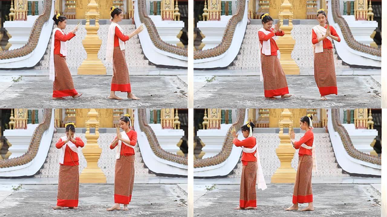 可爱的泰国女孩在寺庙跳舞