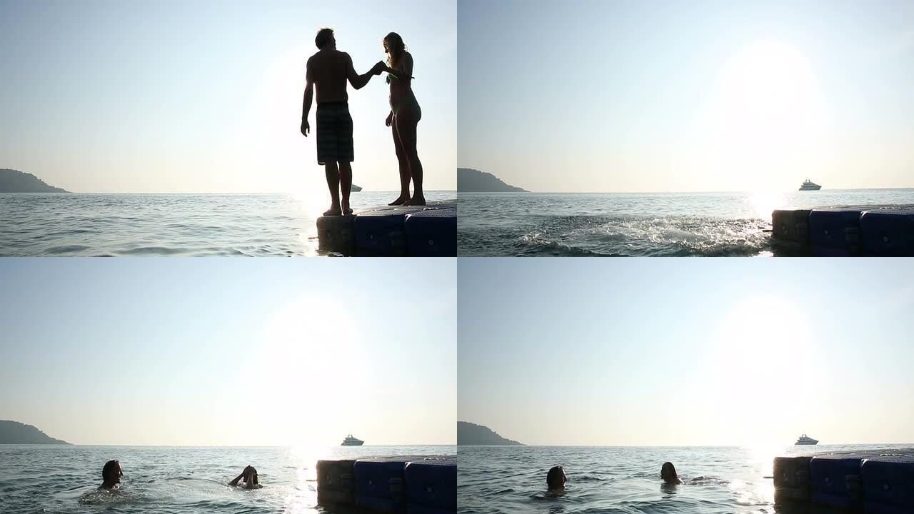日出时，情侣从码头潜入大海