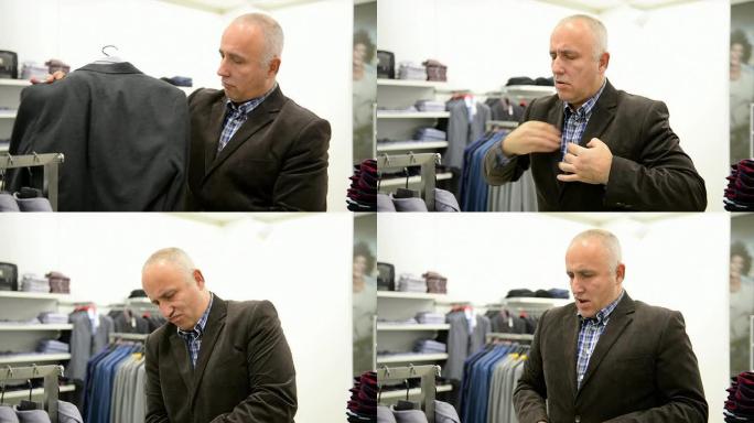 成熟的男人在商场里为自己挑选新衣服。