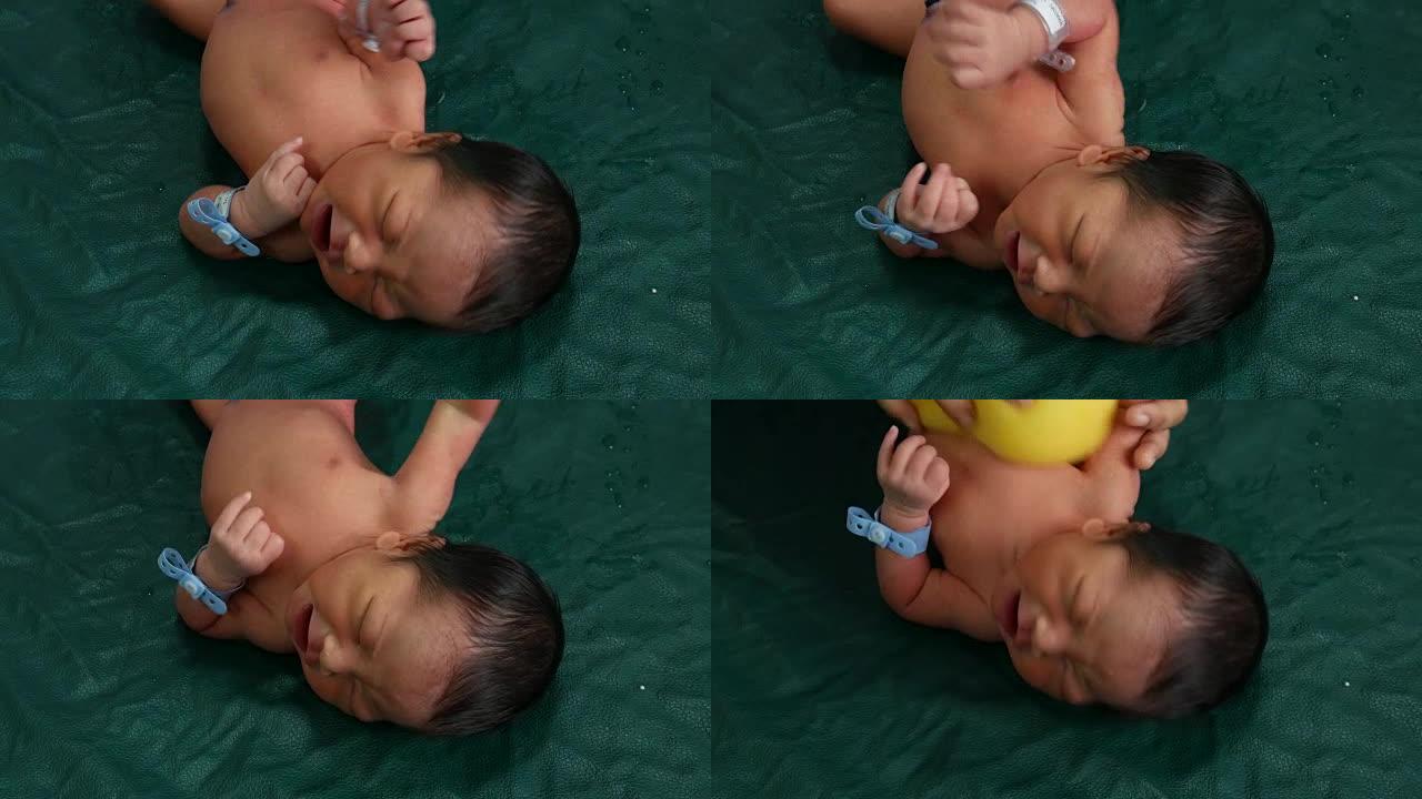 一天大的新生婴儿淋浴的镜头