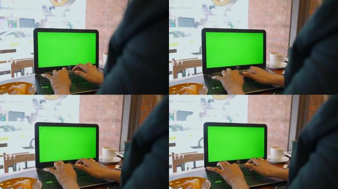 女商人在绿屏笔记本电脑上打字