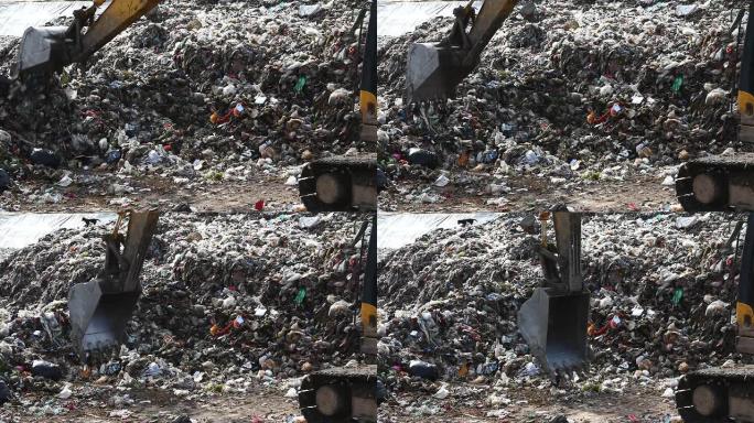 垃圾堆放场挖掘机清理生活垃圾