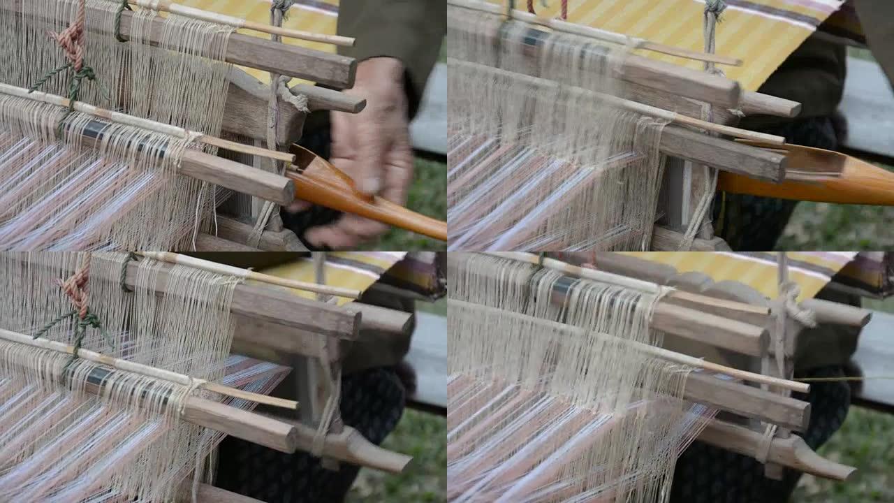女人在手动织布机中以传统方式编织柳条。泰国