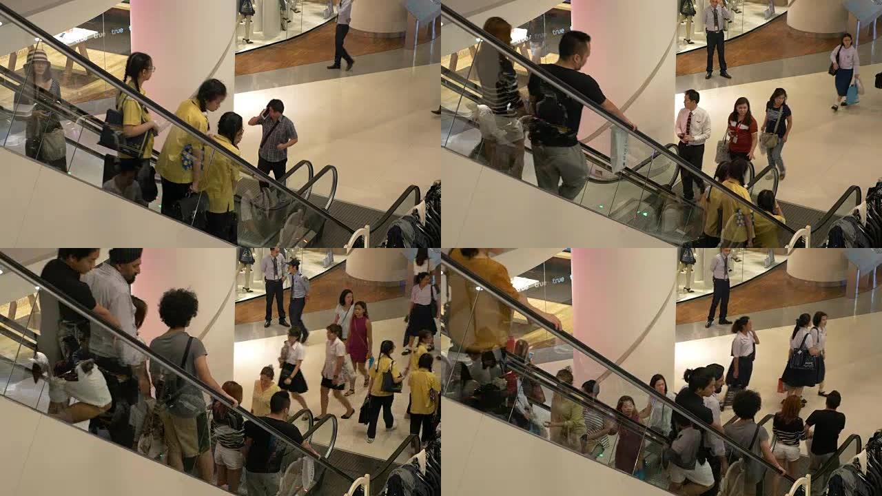 人们在购物中心内的自动扶梯楼梯上移动