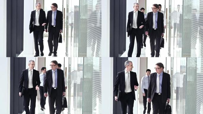 SLO MO两名男性高管走在走廊上