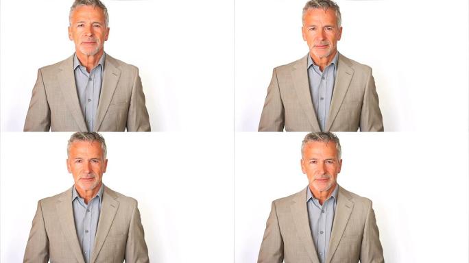 一位英俊的资深商人穿着西装，在白色衣服上看起来很镇定