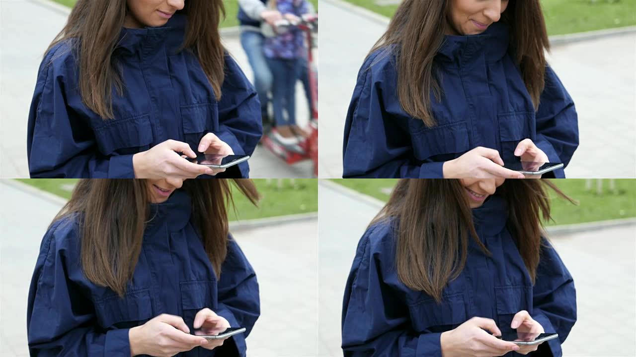 年轻女孩在智能手机上发短信